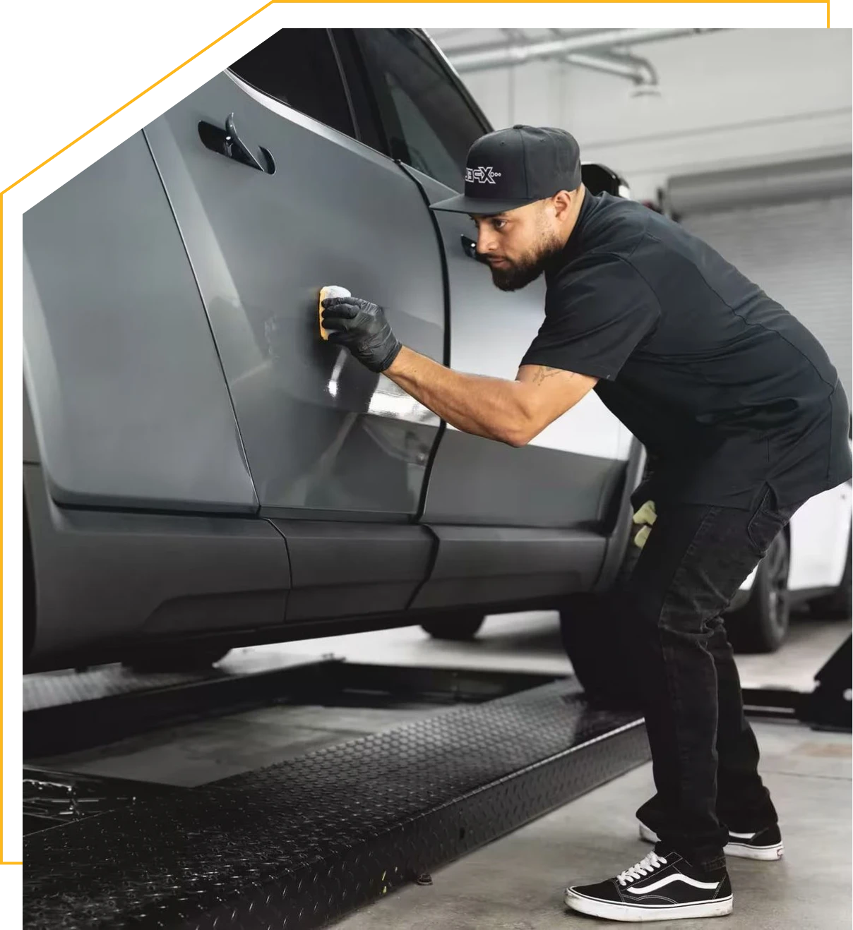 Worker detailing vehicle exterior
