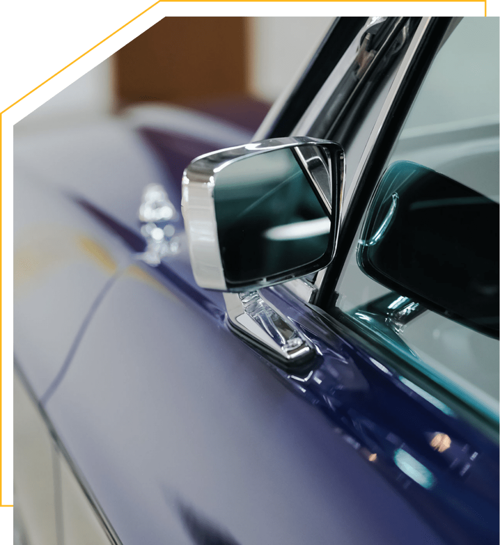 Reflective mirror on blue classic car