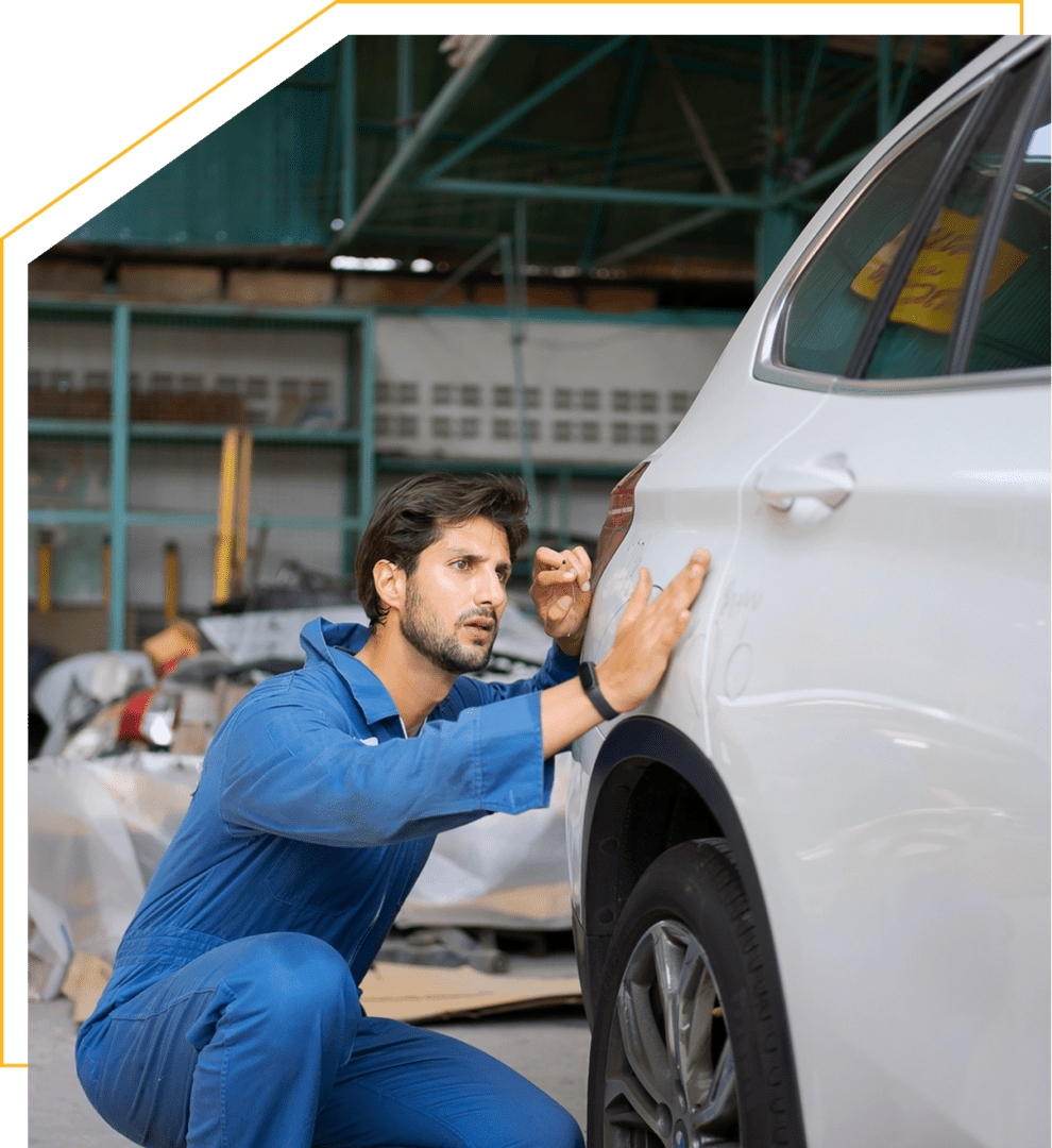 Auto technician examining vehicle damage